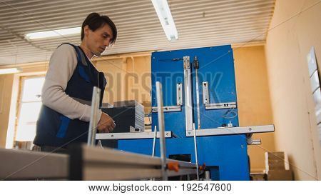 Print operator at work, in a printing factory