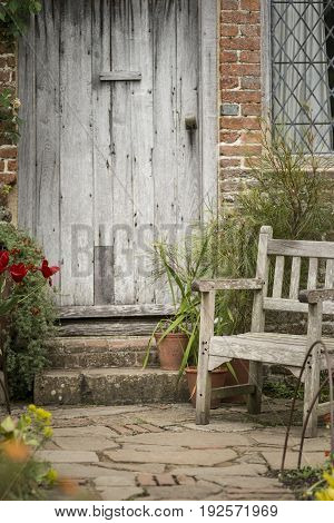 Typical Quintessential Old English Country Garden Image Of Wooden Chair Next To Vintage Back Door