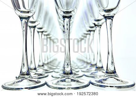 Rows of Empty Wine Glasses on the table white background horizontal