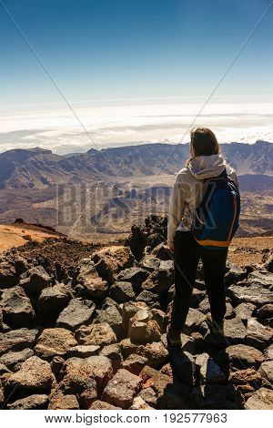 girl is watching the suggestive landscape from the teide volcan
