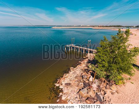 Aerial view of ocean beach. Sand beach and sea view from above. Beach aerial view of ocean water and sand shore. Aerial shot of beach