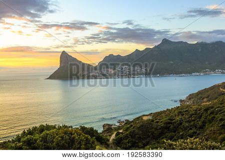 View of Sentinel peak in Hout Bay from the Lookout Point at sunset in Hout Bay from the famous and scenic Chapman's Peak Drive in Cape Town, South Africa.