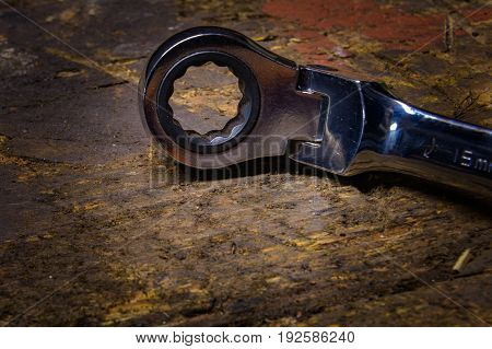 15mm ratchet spanner / wrench on an old wooden workbench