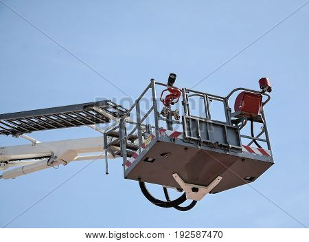white hydraulic construction cradle against the blue sky