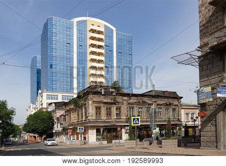 Rostov-on-Don Russia - June 182017: Ancient house with seedling trees at the intersection of the lane Semashko and street Serafimovich.The streets are moving cars