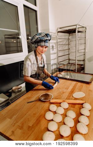 Making cinnamon buns. Homemade raw yeast dough after raising ready to bake, a Baker making cinnamon rolls