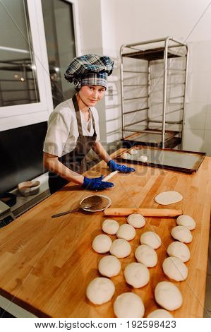 Making cinnamon buns. Homemade raw yeast dough after raising ready to bake, a Baker making cinnamon rolls