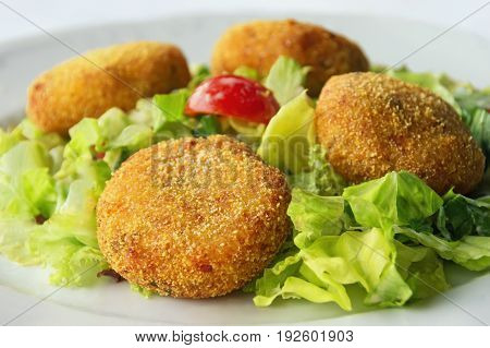 Chicken cutlets with vegetables on white plate