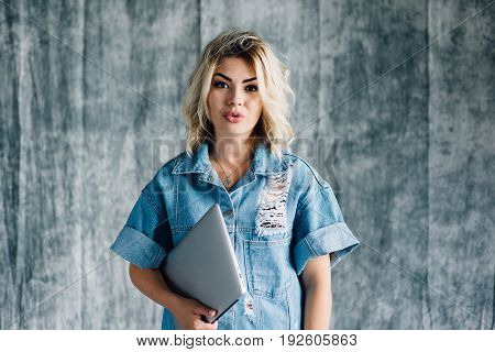 Lovely pretty girl with a laptop smiling and happy that she did the work on time