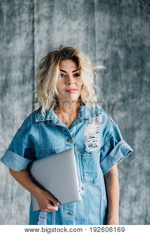 Lovely pretty girl with a laptop smiling and happy that she did the work on time