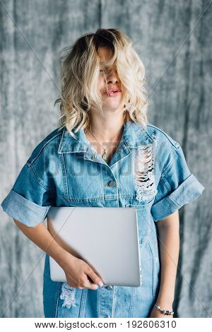 Lovely pretty girl with a laptop smiling and happy that she did the work on time