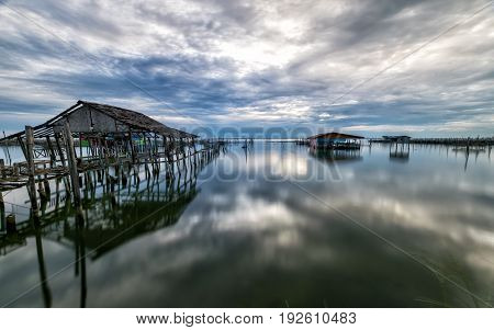 Homestay and floating basket in lake at Kohyo Songkhla Thailand with beautiful sky and clouds. This is traditional fisheries area.