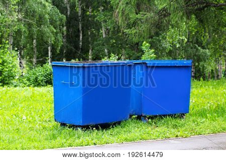 trash cans standing in a row nature