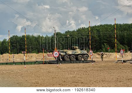 Tyumen, Russia - June 21, 2017: Army Games. Safe Route contest. Motion of BTR-82 amphibious armoured personnel carrier on mechanized bridge