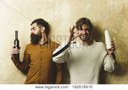 Hipster Looking At Wine Bottle And Happy Man With Yogurt