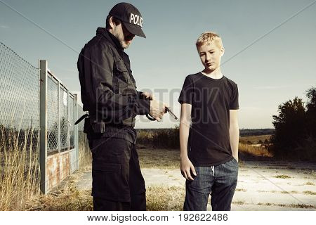 Teenager taken to handcuffs by police man