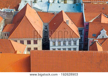 RIGA LATVIA - MAY 05 2017: Tile roofs of the old city Riga. Architecture of old town of Riga. Riga is the capital and the largest city of Latvia widely known due to its unique medieval and Gothic architecture.