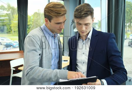 Two businessman dicussing business in the office