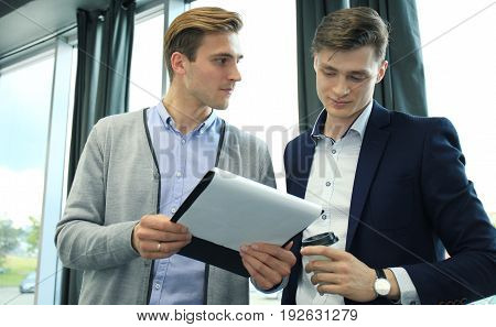 Two businessman dicussing business in the office