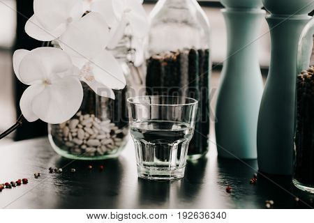 Glass of water. Healthy lifestyle. Flower blurred blackground. Fitness and Losing weight. Diet and Proper nutrition. Vintage toning photo
