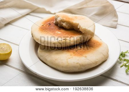 Kulcha is a type of leavened bread originated from the Indian Subcontinent; eaten in India and Pakistan, made from maida. Selective focus. Isolated