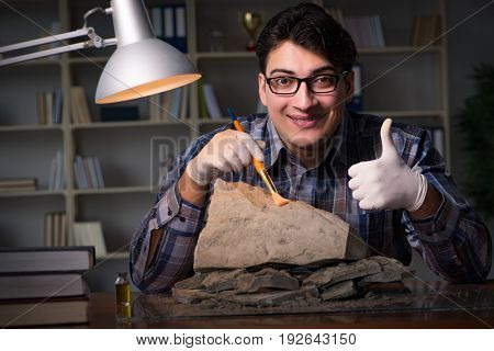 Archeologist working late night in office