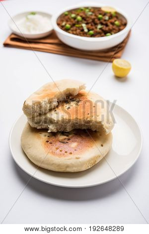 Kulcha is a type of leavened bread originated from the Indian Subcontinent; eaten in India and Pakistan, made from maida. Selective focus. Isolated