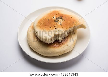 Kulcha is a type of leavened bread originated from the Indian Subcontinent; eaten in India and Pakistan, made from maida. Selective focus. Isolated