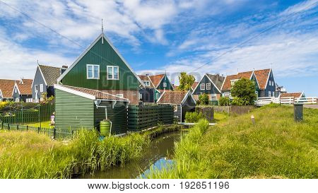 Traditional Dutch Village Scene With Wooden Houses And Canal