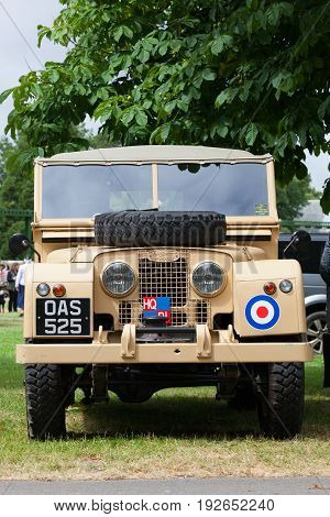 BEAULIEU HAMPSHIRE UNITED KINGDOM - JUNE 25 2017 Land Rover day with many varieties of Land Rovers including this Land Rover Series 1 in a beige color with an RAF sticker parked under a tree.