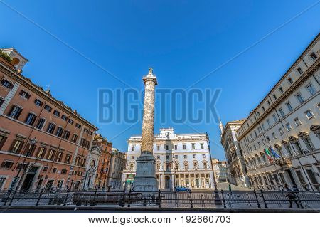 ROME ITALY - MAY 31 2017: Column of emperor Marco Aurelio in Piazza Colonna with engraved the story of the campaign conducted by against the germans. Saint Paul bronze statue at the top.
