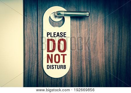 Door of hotel room with sign please do not disturb - retro style