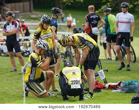 STOCKHOLM SWEDEN - JUNE 11 2017: Mountain bike team fixing the bike before the start in the race cycling at Lida Loop Mountainbike Race. June 11 2017 in Stockholm Sweden
