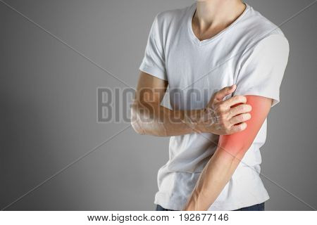 Guy In White Shirt Scratching His Arm. Scabies. Scratch The Hand. Isolated