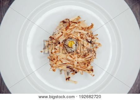 Salad in the form of a nest and decorated with quail eggs.