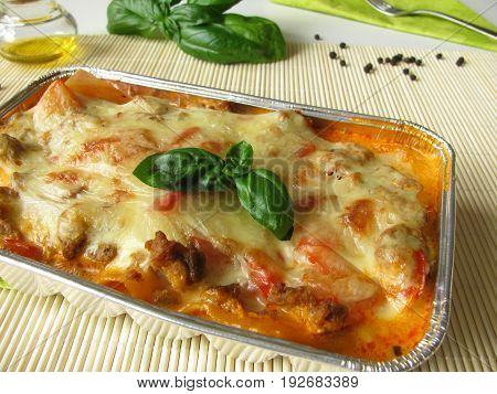 Homemade lasagne with red bell pepper and minced meat in aluminium mold