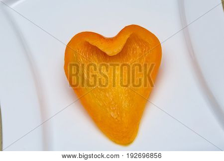 fresh orange peppers Orange pepper on a plate Pepper carved heart
