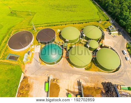 Aerial view over biogas plant and farm in green fields. Renewable energy from biomass. Modern agriculture in Czech Republic and European Union. 
