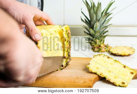 Male Hands Peeling Fresh Pineapple Skin