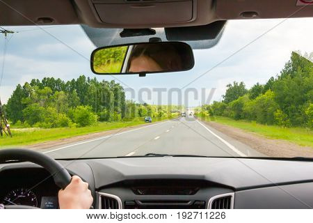 View of the road through the windshield of the car