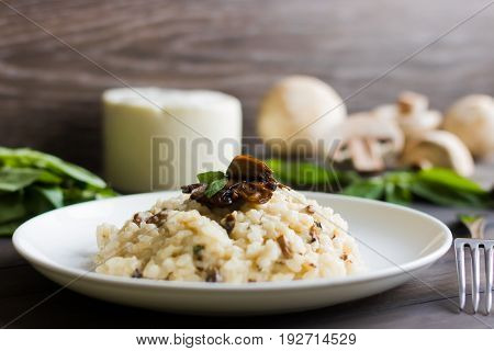 Risotto With Mushrooms On A Dark Wooden Background