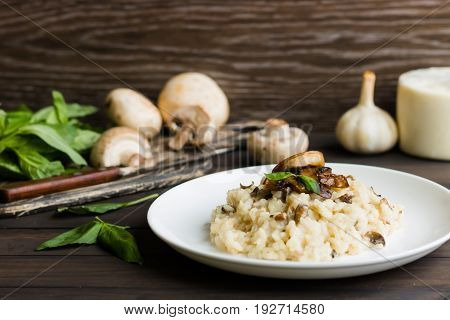 Risotto With Mushrooms On A Dark Wooden Background