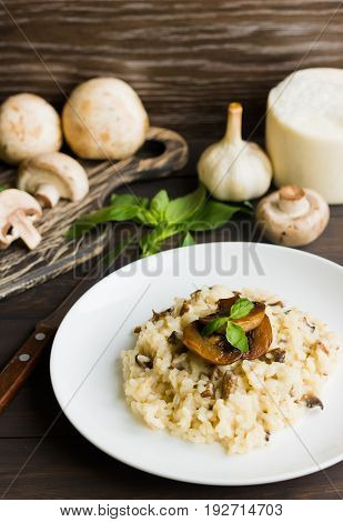 Risotto With Mushrooms On A Dark Wooden Background