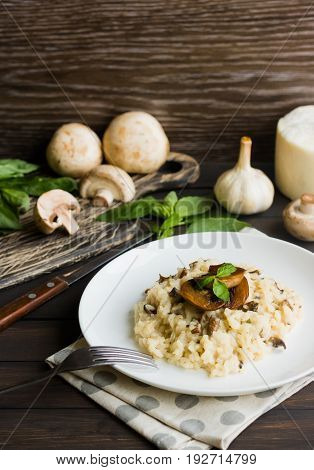 Risotto With Mushrooms On A Dark Wooden Background