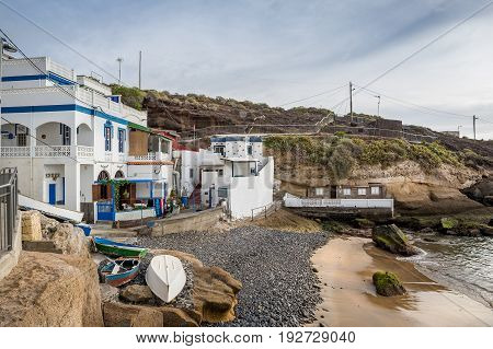 Old houses of El Puertito village, sand beach and traditional wooden fishing boats, Tenerife island