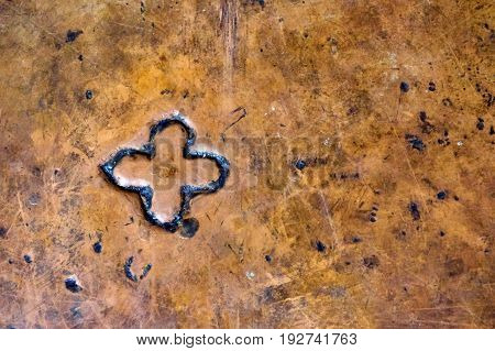 cross hanging on a stone wall, in Church of the Holy Sepulcher in Jerusalem background.