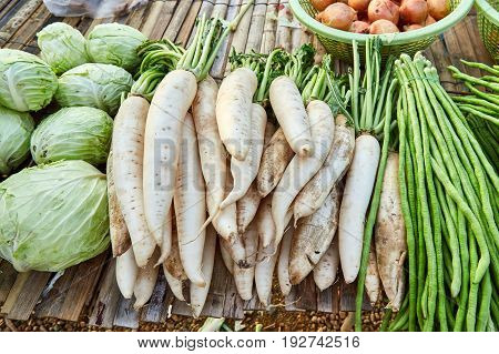 Fresh radish cabbage and yardlong bean on bamboo litter. Vegetables sold in local market