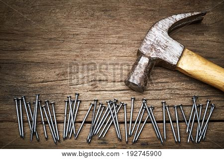 Hammer and nails on old wood background