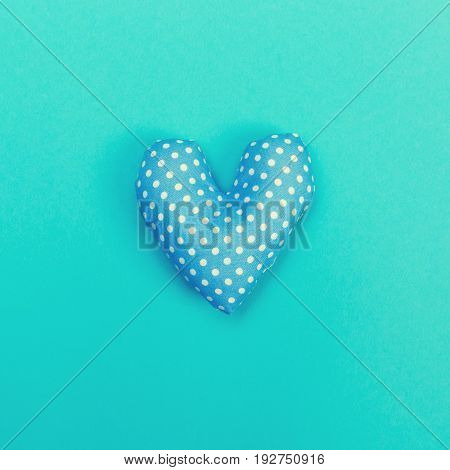 Handmade heart cushions on a blue background