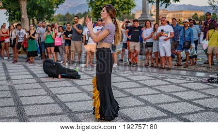 GRANADA, SPAIN - JUNE 23: Unidentified flamenco dancer dances for tourists in St. Nicolas viewpoint to Alhambra in Granada on June 23, 2017 in Spain